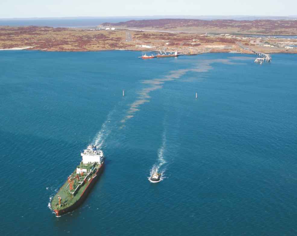 An aerial photo of a ship sailing away from the docks adjacent to the ammonia plant in Western Australia.  It is carrying liquified ammonia