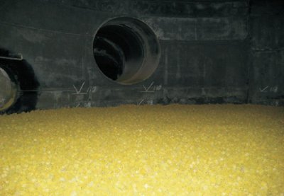 A photograph of a sulfuric acid converter showing vanadium(v) oxide catalyst used in the Contact Process